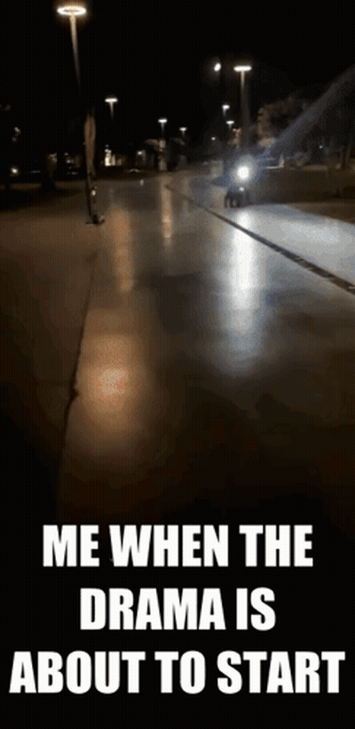 A Motorcycle Is Driving Down A Street At Night With A Caption That Says Me When The Drama Is About To Start . GIF