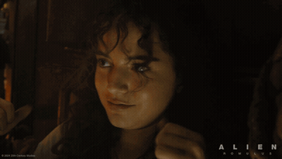 A Movie Poster For Alien Romulus Shows A Woman Giving The Thumbs Up GIF
