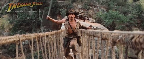 A Movie Poster For Indiana Jones Shows A Man Crossing A Bridge GIF
