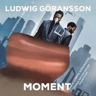 A Movie Poster For Moment Shows Two Men In Suits GIF