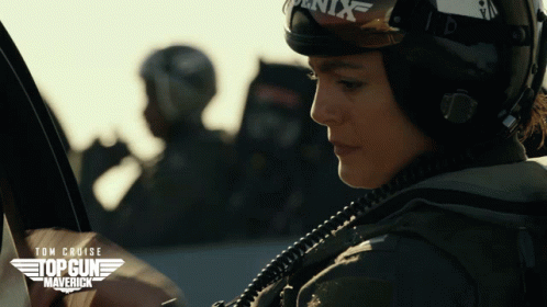 A Movie Poster For Top Gun Maverick Shows A Woman Wearing A Helmet And Goggles GIF