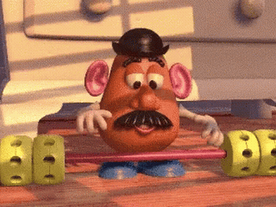 A Mr Potato Head Is Holding A Barbell In His Hands GIF