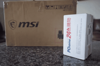 A Msi Box Sits Next To A Pchome Box On A Table GIF