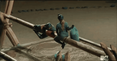 A Mtv Logo Can Be Seen On A Screen Behind Two People GIF