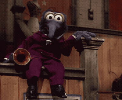 A Muppet In A Purple Suit Sits On A Railing Playing A Trumpet GIF