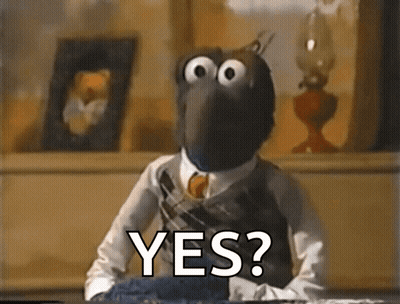 A Muppet Is Sitting At A Table With The Words Yes Written On It GIF