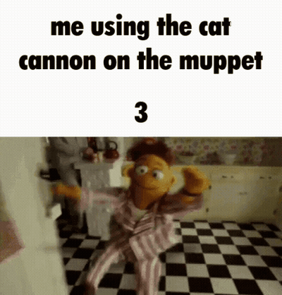 A Muppet Is Sitting On A Checkered Floor In A Kitchen And Using The Cat Cannon On The Muppet Show . GIF