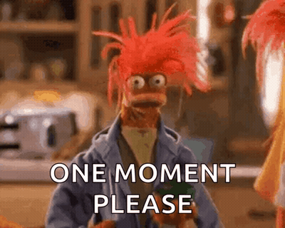 A Muppet With Red Hair Is Asking For A Moment Please GIF