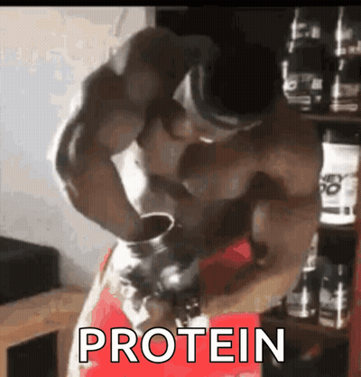 A Muscular Man Is Drinking Protein From A Bottle . GIF