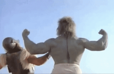 A Muscular Man Is Flexing His Muscles While Standing Next To Another Man . GIF