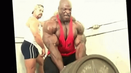 A Muscular Man Is Lifting A Barbell In A Gym . GIF