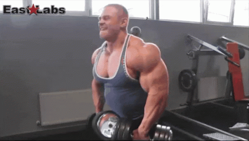 A Muscular Man Is Lifting A Dumbbell In A Gym With The Words Easy Labs In The Corner GIF