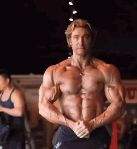 Muscular Man Posing In Gym With Hands On Hips GIF