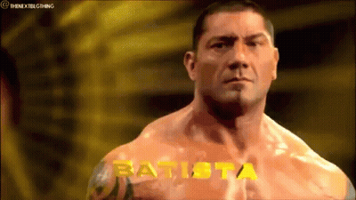 A Muscular Man With The Name Batista Written On His Chest GIF