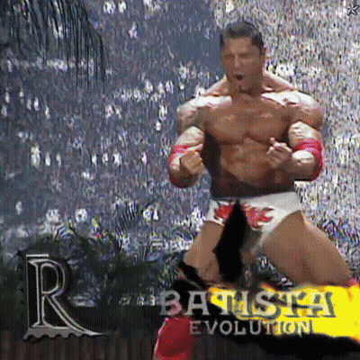 A Muscular Wrestler Is Standing In Front Of A Crowd And The Words Batista Evolution Are On The Screen GIF