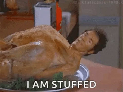 A Naked Man Is Laying On A Plate Of Stuffed Turkey And Says `` I Am Stuffed '' . GIF