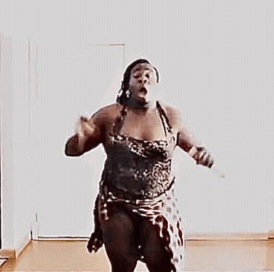 A Naked Woman Is Jumping In The Air With Her Arms Outstretched GIF