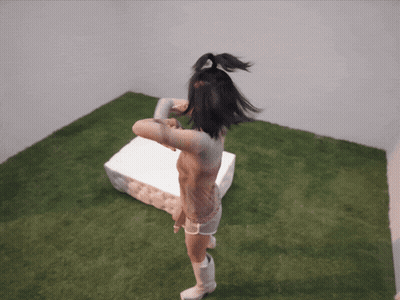 A Naked Woman Is Standing In A Room With A White Box GIF