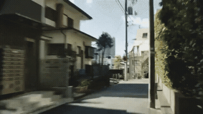 A Narrow Street With A Few Houses On The Side GIF