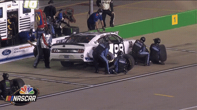 A Nascar Race Car Is Being Worked On By Mechanics GIF