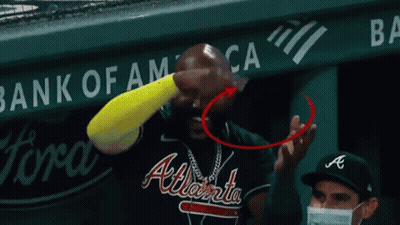 A National Car Rental Sign Is Behind A Baseball Field GIF