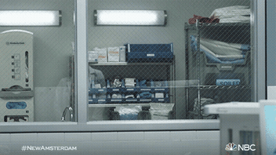 A Nbc Advertisement For Newamsterdam Shows A Nurse Behind A Fence GIF