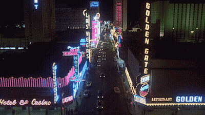 A Neon Sign For The Golden Gate Restaurant Is Lit Up GIF