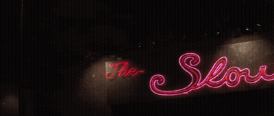 A Neon Sign For The Low Club With A Deer Head On It GIF