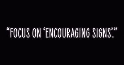 A Neon Sign That Says Focus On Encouraging Signs On A Black Background GIF
