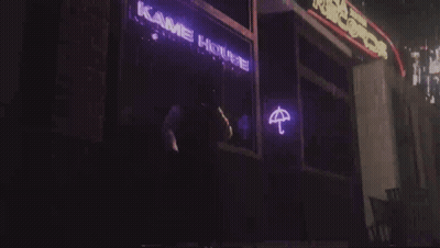 A Neon Sign That Says Kame House With An Umbrella On It GIF