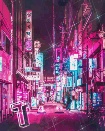 A Neon Sign That Says ' T ' On It Is In The Middle Of A City Street GIF