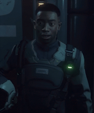 A Neon Sign That Says Wish Him Luck With A Man Behind It GIF