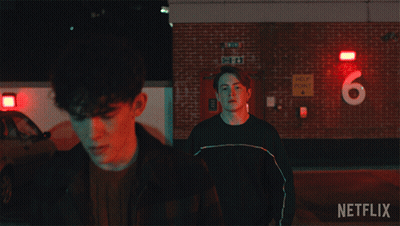 A Netflix Ad For A Movie Shows A Man Holding Another Man 'S Arm GIF