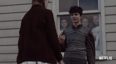 A Netflix Ad Shows A Boy And A Woman Holding Hands GIF