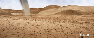 A Netflix Ad Shows A Desert With A Tornado In The Background GIF