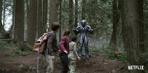 A Netflix Ad Shows A Group Of Children Standing In A Forest GIF