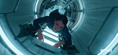 A Netflix Ad Shows A Woman Floating Through A Tunnel GIF