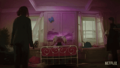 A Netflix Ad Shows A Woman Standing In Front Of A Girl On A Bed GIF