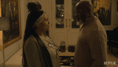 A Netflix Ad Shows A Woman Walking Down Stairs GIF