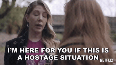 A Netflix Ad Shows Two Women Talking And One Says I 'M Here For You If This Is A Hostage Situation GIF