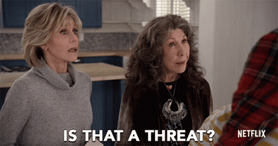 A Netflix Ad Shows Two Women Talking To Someone GIF