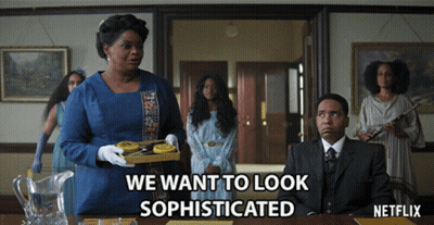 A Netflix Advertisement Shows A Woman Holding A Tray Of Cookies GIF