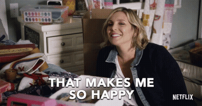 A Netflix Advertisement Shows A Woman Sitting On A Bed Smiling And Saying That Makes Me So Happy GIF