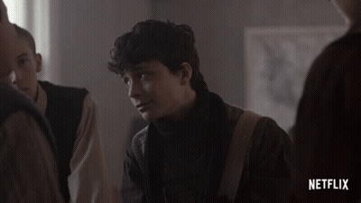 A Netflix Advertisement Shows A Young Man Looking At Something GIF