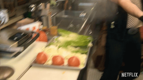 A Netflix Logo Can Be Seen In The Corner Of A Kitchen Scene GIF