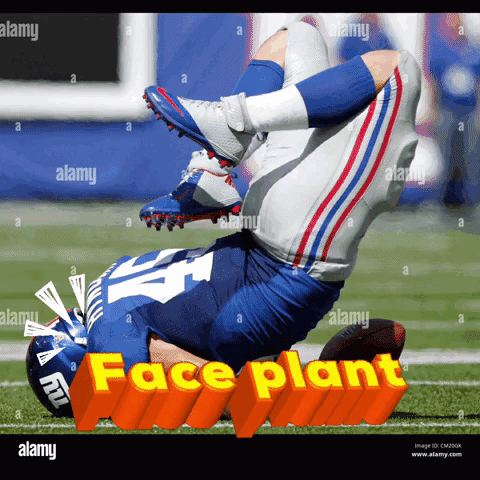 A New York Giants Football Player Is Laying On His Back On The Field During A Game GIF