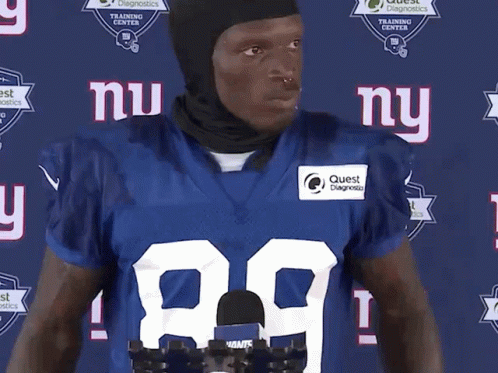 A New York Giants Football Player Wearing A Black Helmet GIF
