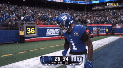 A New York Giants Player Celebrates A Touchdown During A Game GIF