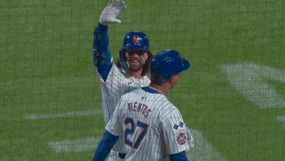 a new york mets baseball player is waving his hand