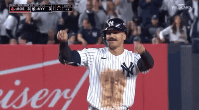 A New York Yankees Baseball Player Celebrates A Home Run In Front Of A Budweiser Advertisement GIF